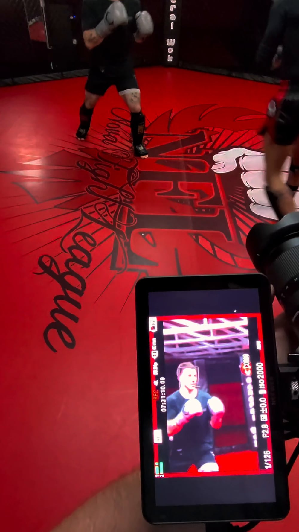 Moniteur filmant un entraînement de boxe